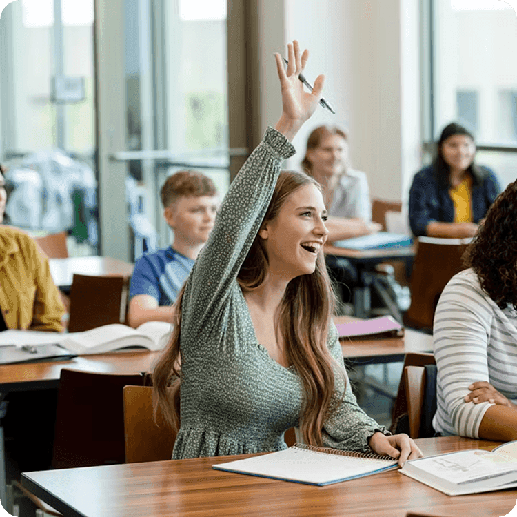 Student raising hand enthusiastically in classroom